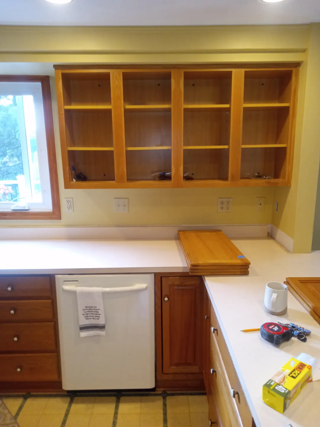 Kitchen upper cabinets with the doors removed for painting