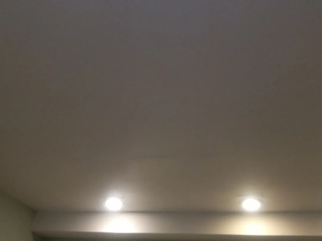 Freshly painted basement ceiling with two recessed lights