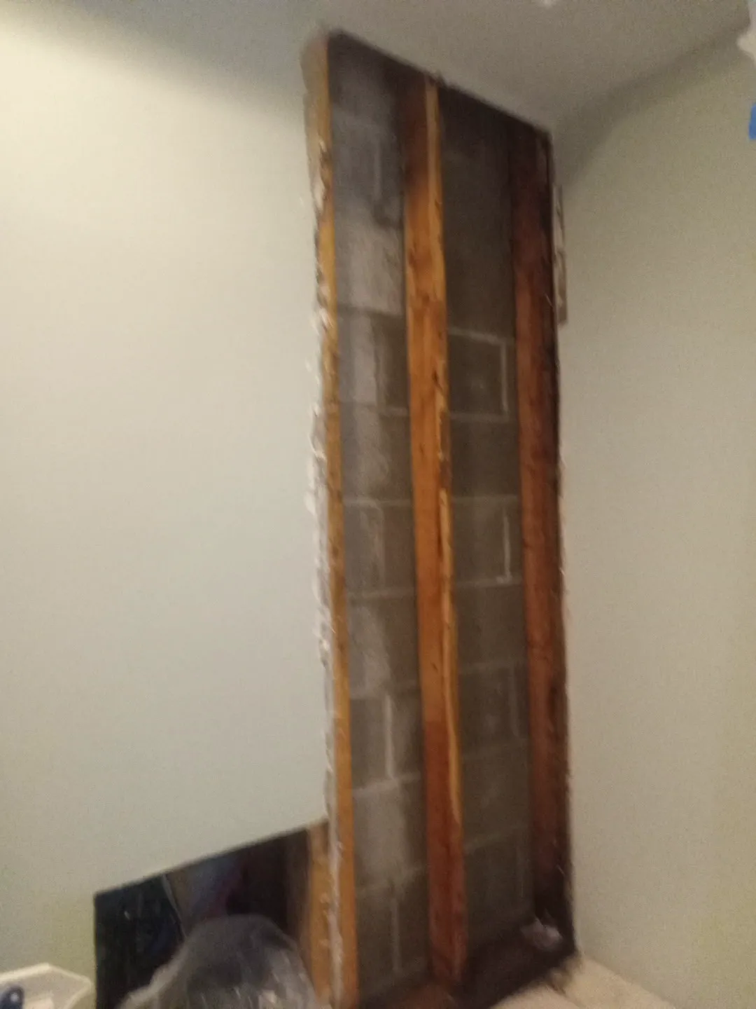 Basement wall with the drywall cut out down to the block wall