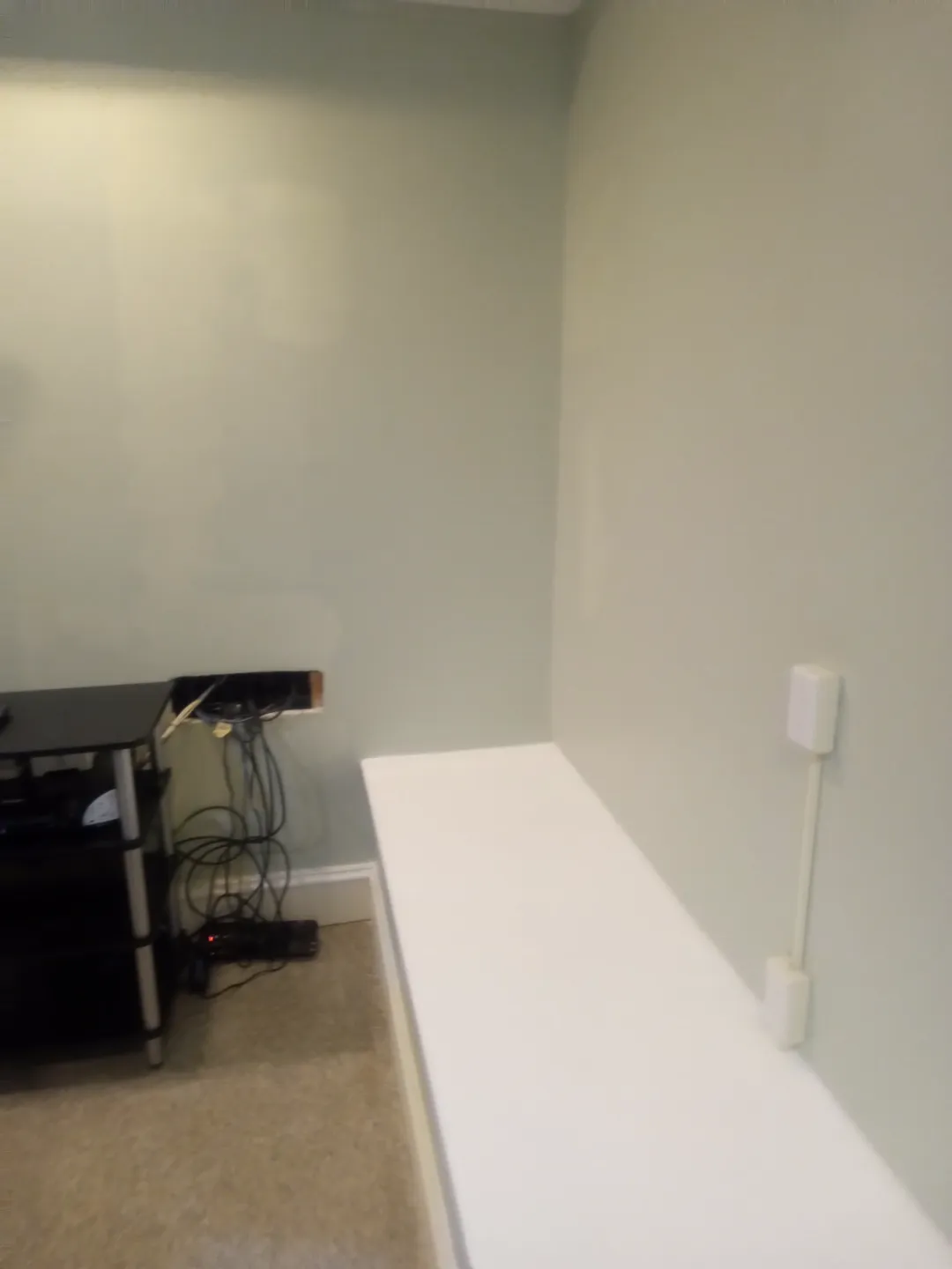 The basement wall painted to match after the repair